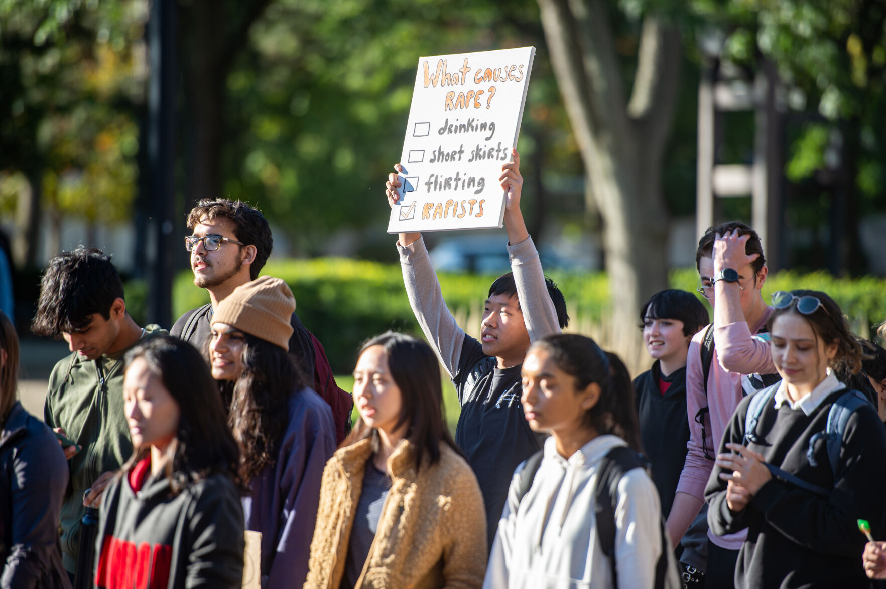 Students rally in support of MeToo movement, Student holds sign